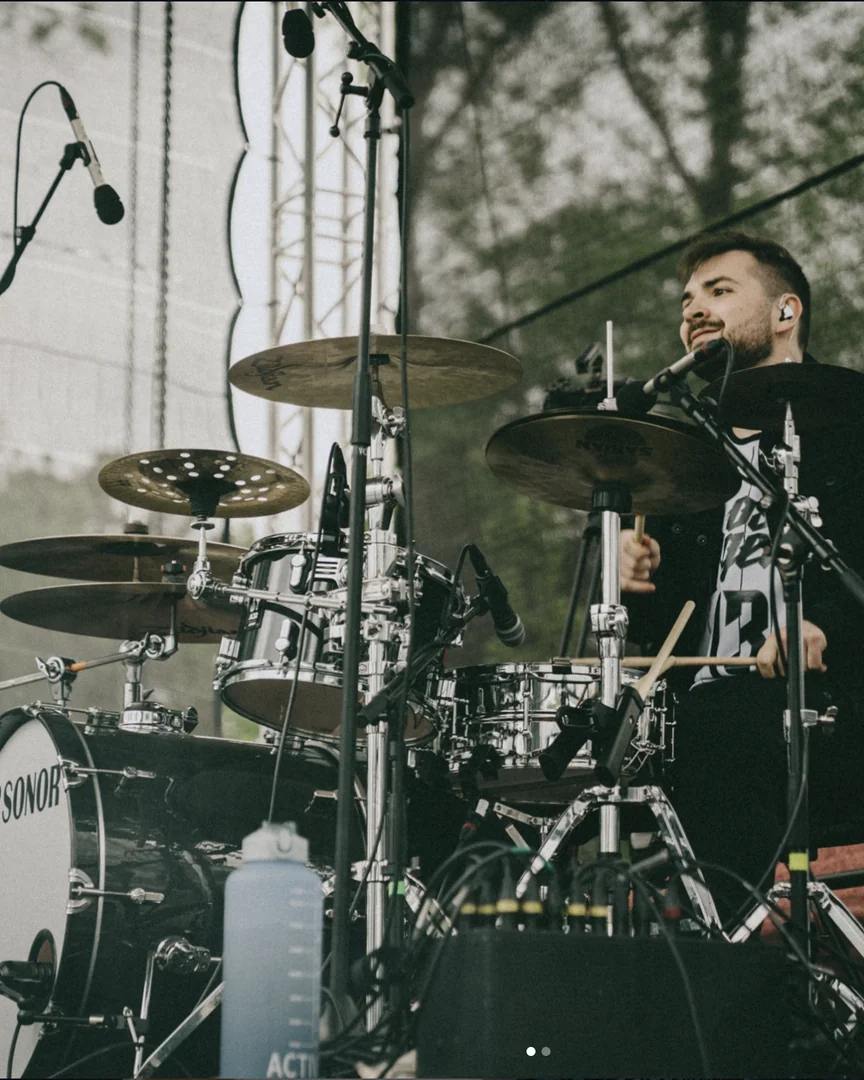 Vojta playing drums on stage